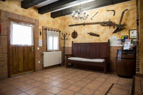 a room with a bench and a window and a door at Casa Rural Julian in Medinaceli