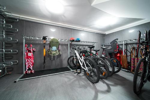 a garage with bikes and ski equipment in it at Górska Legenda Apartamenty & Domki in Szczyrk