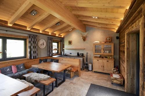 a living room with a table and a kitchen at Appartments Weiss in Westendorf