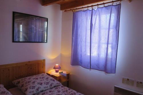 a bedroom with a bed and a window with a lamp at Holiday home at Aquapark Tatralandia in Liptovský Mikuláš
