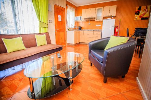 a living room with a couch and a glass table at Marina Pichilemu in Pichilemu