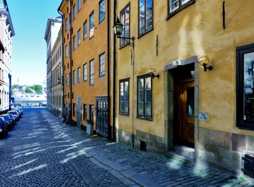 an empty street in a city with buildings at Gamla Stan Apartments in Stockholm