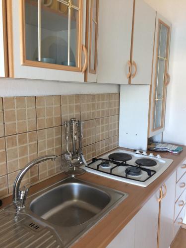 a kitchen with a sink and a stove at Villa Ana in Pag