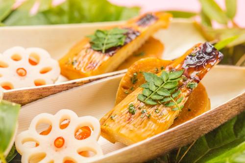 a plate of food with salmon and herbs on it at 高野山 宿坊 総持院 -Koyasan Shukubo Sojiin- in Koyasan