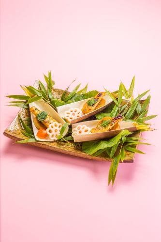 a plate with three food items on top of leaves at 高野山 宿坊 総持院 -Koyasan Shukubo Sojiin- in Koyasan