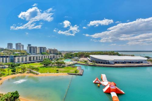 an airplane in the water in front of a stadium at Darwin Waterfront Short Stay Apartments in Darwin