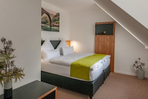 a bedroom with a bed in a room at Hotel Drei Tannen in Moosburg