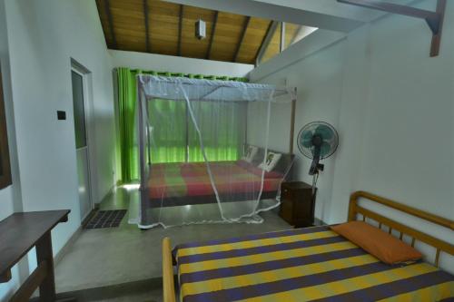 a bedroom with a bed with a mosquito net at Victoria House by Srilanka Tripper in Kandy