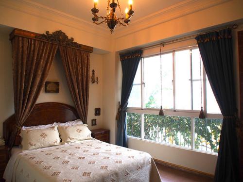 a bedroom with a bed and a large window at Posia 122 in Tainan