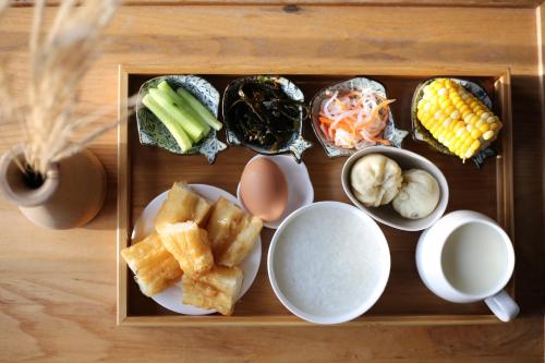 a tray of food with different types of food on it at Dali Shaxi Qing Jing Courtyard in Jianchuan
