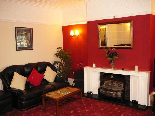 a living room with a couch and a fireplace at The Craigmore in Blackpool