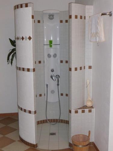 a shower stall in a bathroom with tiles at Appartmenthaus Moos Bäu in Lam