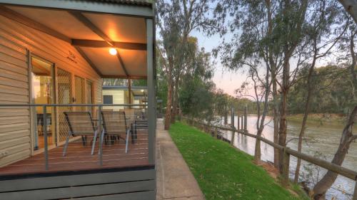 a house with a balcony with a view of a river at Moama Riverside Holiday Park in Moama