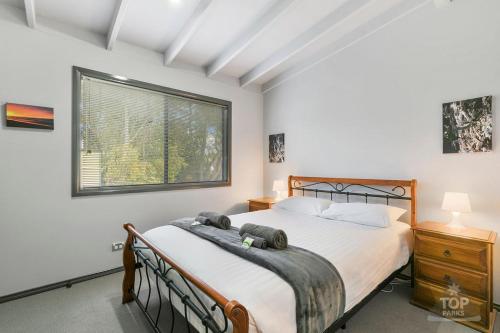 a bedroom with a large bed and a window at Yarram Holiday Park in Yarram