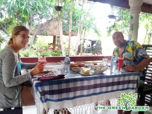 a man and a woman sitting at a table with food at The Green Garden in Dambulla