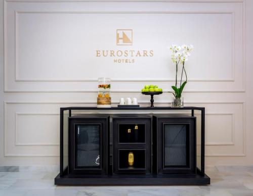 a black table in a room with a wall at Eurostars Puerta Real in Granada