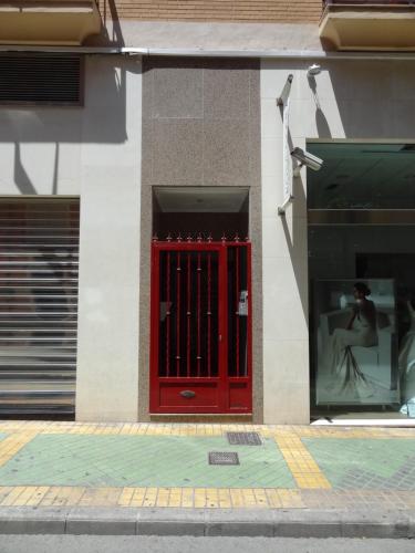 a red door on the side of a building at Amazing Condo in Alicante City Center in Alicante