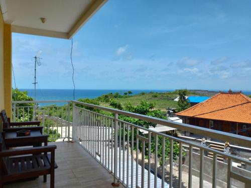 a balcony with a view of the ocean at Balangan Paradise Hostel and Restaurant in Jimbaran