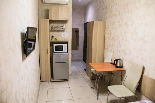 a small kitchen with a table and a microwave at Bolshaya Morskaya 7 in Saint Petersburg