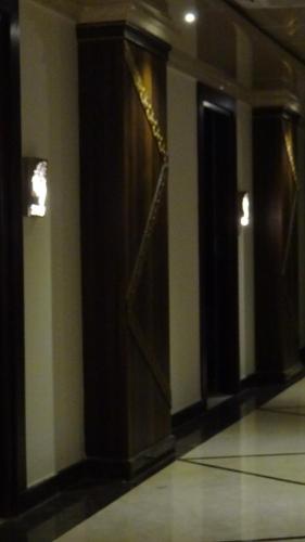 an empty hallway with a door in a building at Arna Hotel in Devanahalli-Bangalore