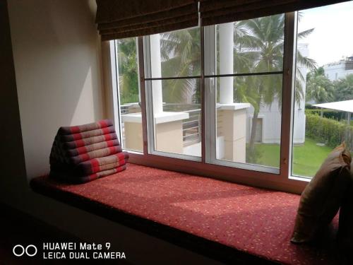 a window seat with a pillow in front of a window at Hua Hin Blue Lagoon in Cha Am