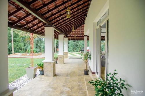 an empty porch of a house with potted plants at Cogent Holiday Home in Gelioya