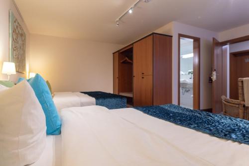 a hotel room with two beds and a cabinet at Princess No3 Self Check-In Plochingen bei Stuttgart in Plochingen