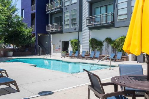 a swimming pool in front of a building at Trifecta 10 Min Walk to 7th St Market Superhost in Charlotte