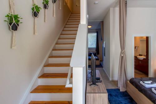 a staircase in a house with potted plants on the walls at Trifecta 10 Min Walk to 7th St Market Superhost in Charlotte