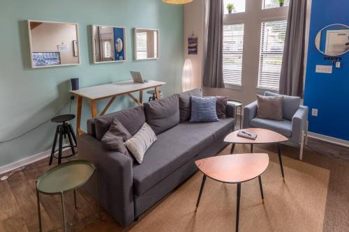 a living room with a couch and two tables at Trifecta 10 Min Walk to Epicentre Superhost in Charlotte