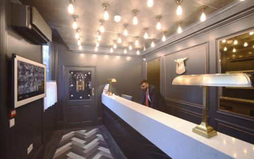 a man standing at a counter in a bar at The House of Toby in London