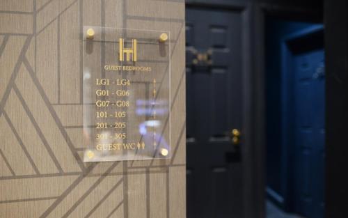 a wooden door with a sign on it with the wordsynthesis at The House of Toby in London