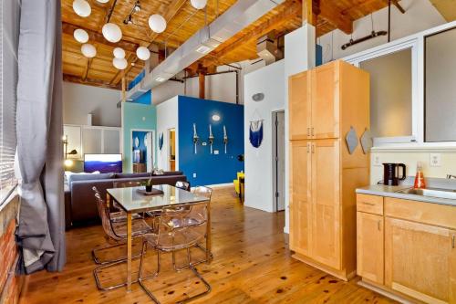 a kitchen and living room with a table and a couch at Trifecta Historic Brick 2BR Getaway Superhost in Durham