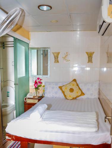 a large bed in a room with a bathroom at Everest Hostel 14/F in Hong Kong