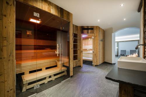 a bathroom with a tub and a sink at Knappensteig Appartements in Wagrain