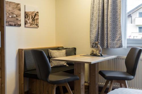 a dining room with a table and two chairs at Knappensteig Appartements in Wagrain