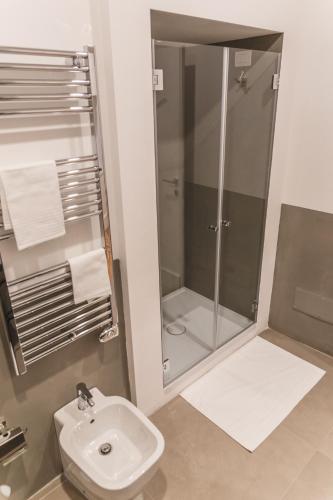 a bathroom with a shower and a toilet and a sink at Relais Della Porta in Naples