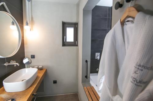 a bathroom with a sink and a mirror at Marquise Suites - Adults Only in Fira