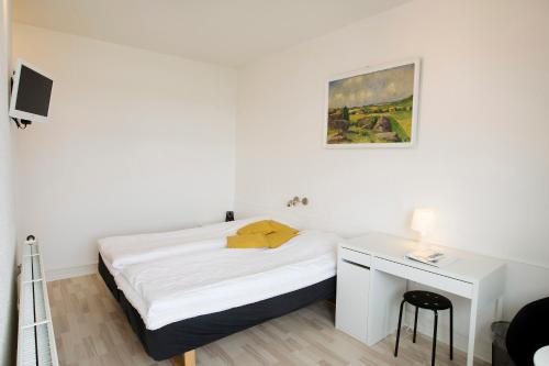 Postel nebo postele na pokoji v ubytování Hotel Troense