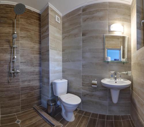 a bathroom with a toilet and a sink at Jupiter 1 Family Hotel in Balchik