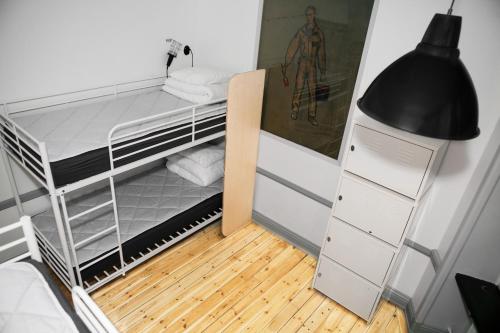 a small room with a bunk bed and a lamp at City Backpackers Hostel in Stockholm