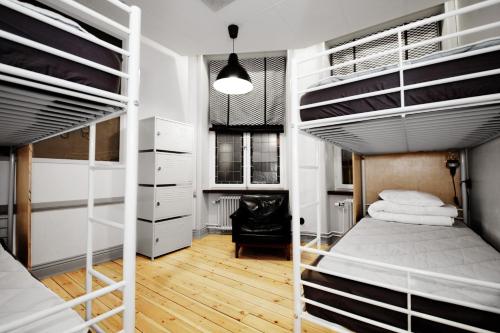 a bedroom with two bunk beds and a desk at City Backpackers Hostel in Stockholm