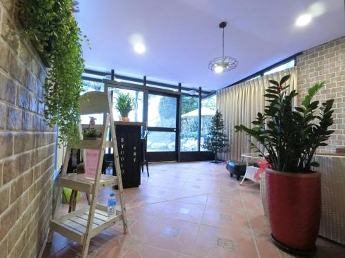 a room with potted plants and a staircase in it at 吉祥城堡 Propitious Castle B&B in Zhixue