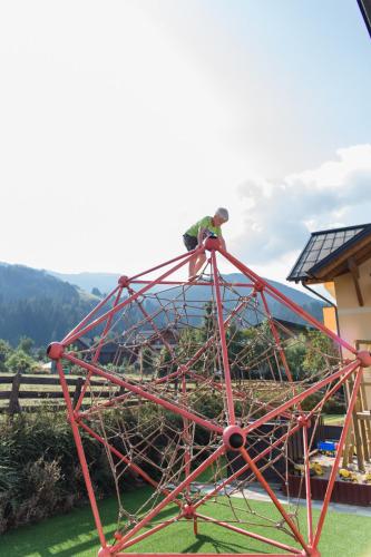 a man standing on top of a roller coaster at Knappensteig Appartements in Wagrain