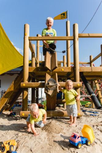 two children playing in the sand on a playground at Knappensteig Appartements in Wagrain