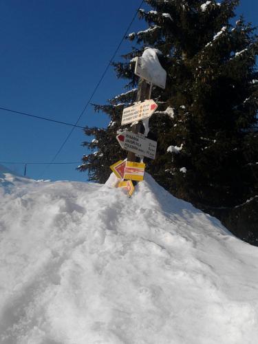 a pile of snow with a pile of signs in it at Pension Arnika in Modrava