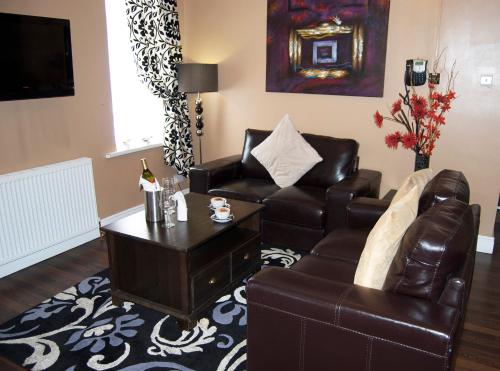 a living room with a couch and a coffee table at Villaggio in Warrington