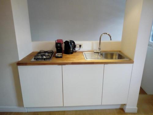 a kitchen counter with a sink and a stove at Maison Montana in Brussels