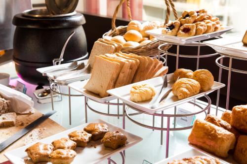 a display of different types of bread and pastries at Citymax Hotel Al Barsha in Dubai