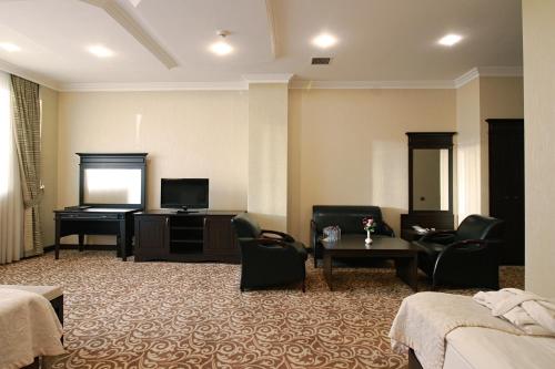 a hotel room with a bed and a television at New Baku Hotel in Baku